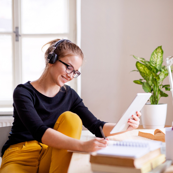 woman studying notes and working at computer