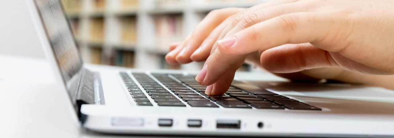 fingers typing on a laptop