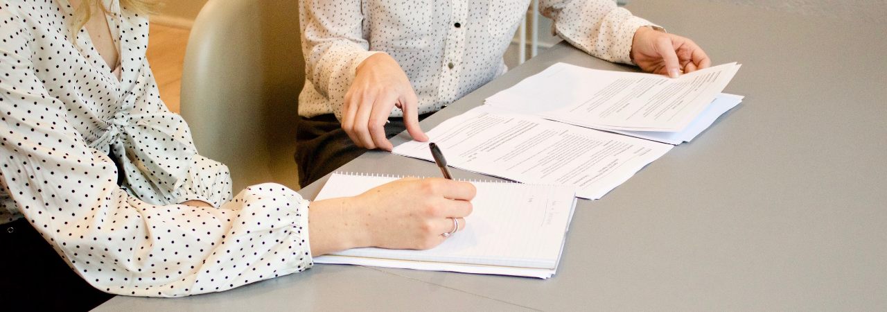 employees signing papers