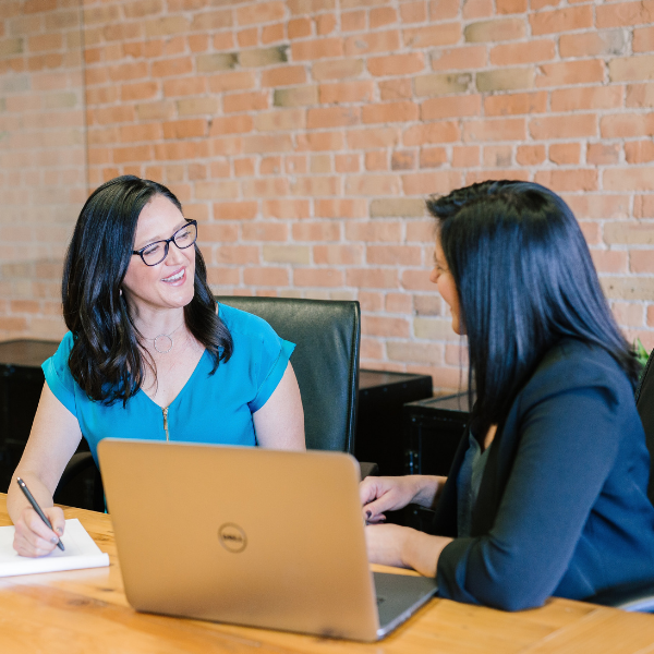 Two female legal assistants talking