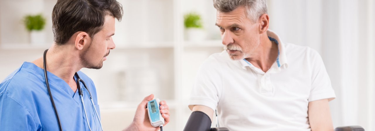 male nurse checking a patient's blood pressure