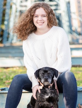 Sailor Anglin and her dog in front of the Chatanooga walking bridge
