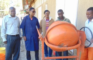 Research Team at Mbeya University of Science and Technology (MUST). From left to right Mr. Joseph Mnkeni and Ms. Shamsa Nassibu, Instructors at MUST; Dr. Mbaki Onyango Assistant Professor at UTC and Ayubu Daniel and Isaya Benard, helping with block making.