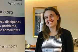 Kathryn Rouse standing besud poster