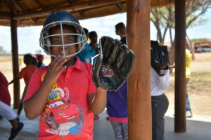 Kid with baseball helmet and glove on