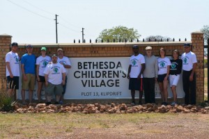 Baseball Miracles team in front of Bethesda Children's Village sign