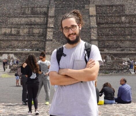 A person in front of a pyramid