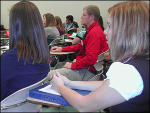 Paige Odom, right, listens to student colleagues in the simulated House of Representatives present their cases.