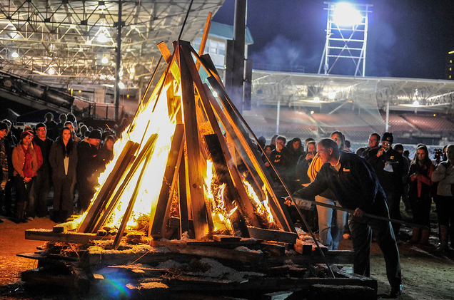 Mocs Football Coach Russ Huesman lighting the fire
