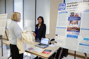 Visitors Talk with Booth Attendant at Accessible Technology Fair