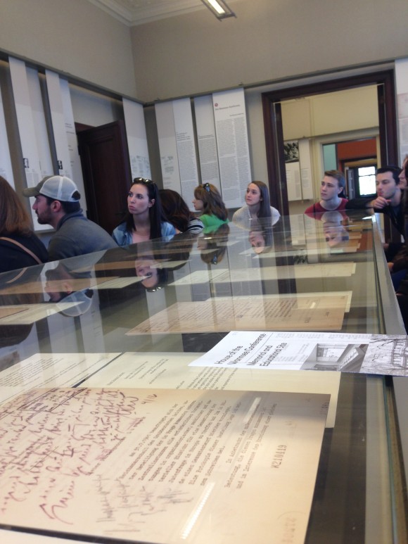  UTC students sit around the conference table setting of the Wannsee House where the Final Solution was discussed.
