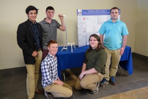 Engineering team consisting of Hector Gutierrez, Cody Flowers, Erik Dale, Nick Pierson, Dillon Grider posing with the assistive device they created.