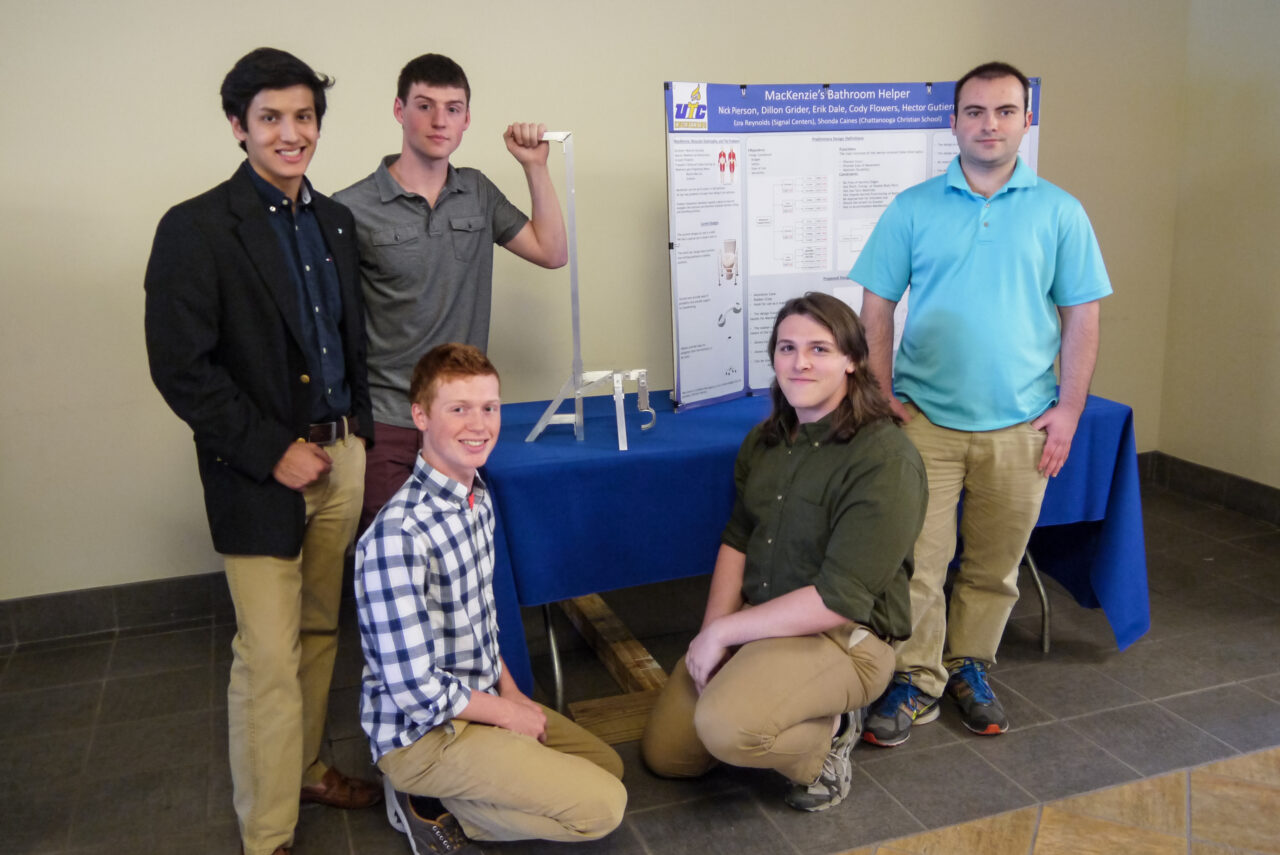 Engineering team consisting of Hector Gutierrez, Cody Flowers, Erik Dale, Nick Pierson, Dillon Grider posing with the assistive device they created.