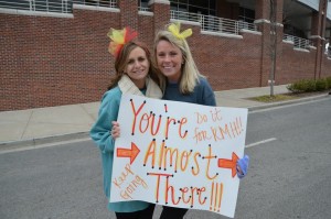 ADPi Ronald McDonald House Run spectators holding sign, "You're almost there!"