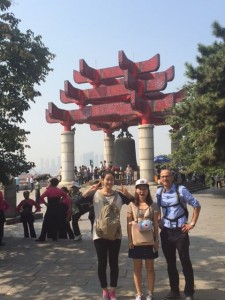 Dr. Gary Liguori standing in front of an arch with his hosts from Wuhan University in China.