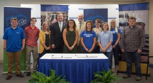 students and administrators at signing