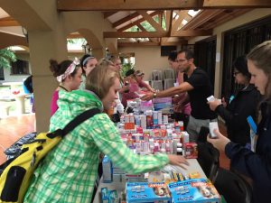 Nursing students working at the clinic, helping at the pharmacy table.
