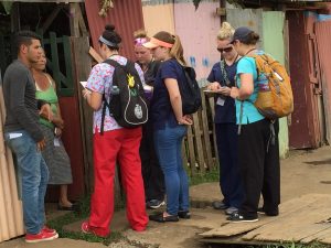 UTC students going door to door to invite people to come out to the clinic.