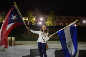 Student waves flags at this year's International Festival Parade of Flags