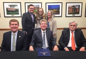 Participating in the signing ceremony were, seated left to right: UTC Chancellor Steve Angle; Motlow State President Tony Kinkel; and Charles Wharton, who represents the Franklin County and Lynchburg areas on the University of Tennessee Board of Trustees. Standing left to right are: Scott Cook, Motlow State Honors Program director; JuliAnna Dykes, a Motlow State honors student; and Linda Frost, UTC Honors College dean.