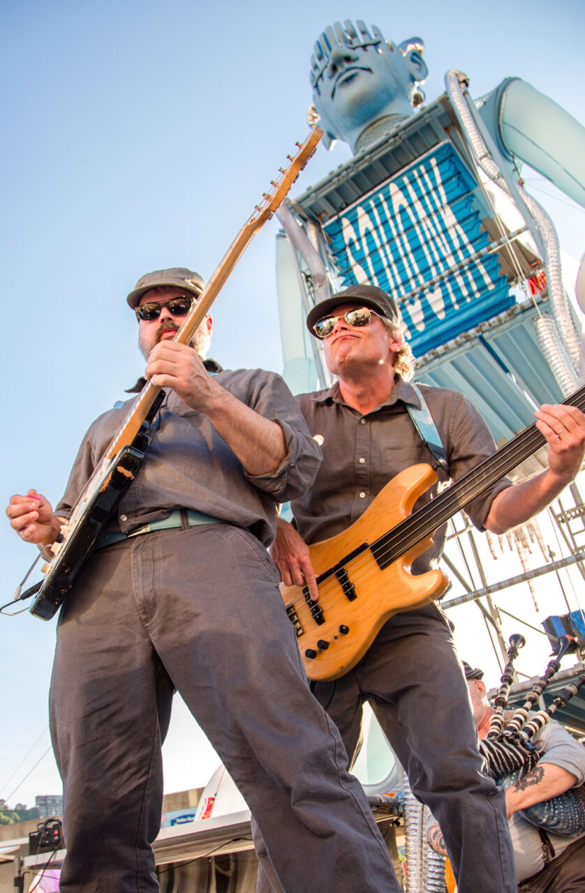 2 men playing guitars