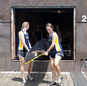 Women’s Novice 4+ Rowing team at UTC carrying their boat