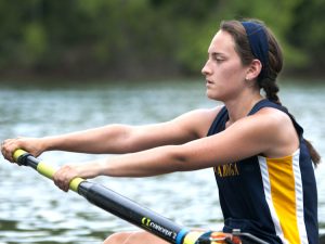 One of the members of the Women’s Novice 4+ Rowing team at UTC giving it her all during a rowing competition.