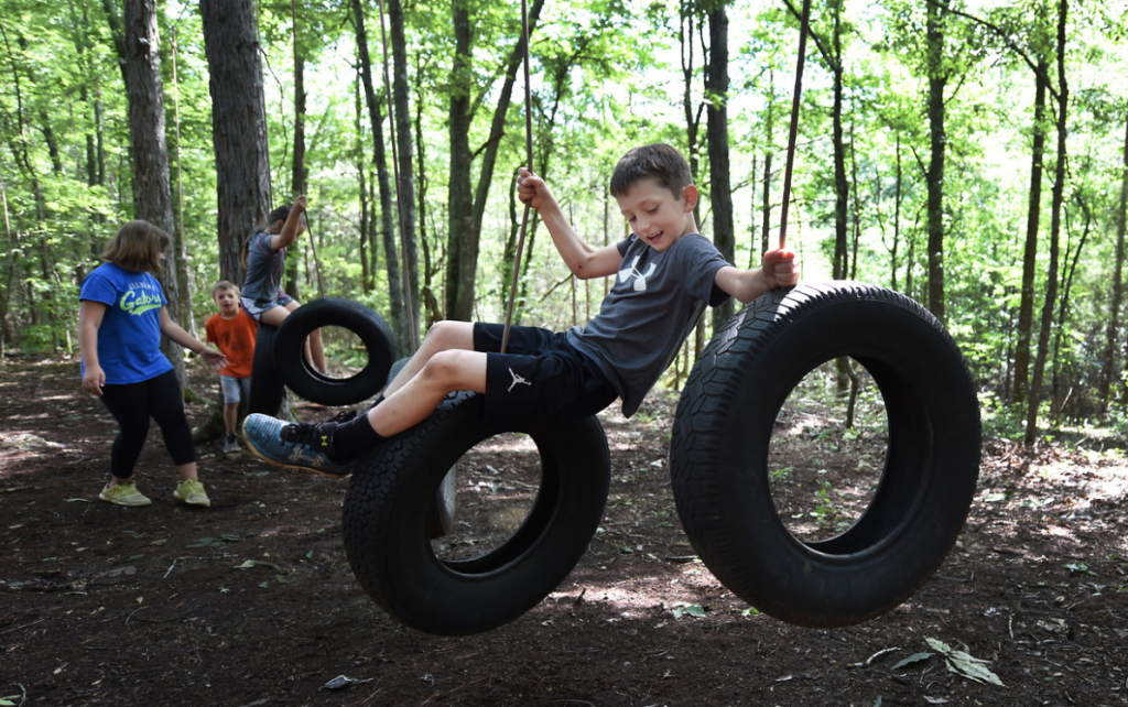 Elementary school student playing on ropes course
