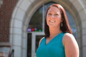 Melissa Speed poses in front of Founders Hall