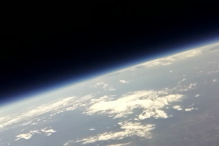 View from the edge of space near 100,000 ft. The fading atmosphere can be seen transitioning from blue to black. The air pressure is approximately 1/100th of an atmosphere.