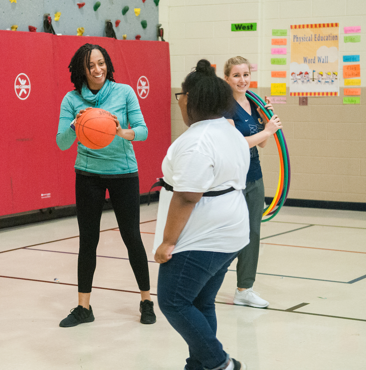 Kori Hahn and Shewanee Howard-Baptiste play with Orchard Knob student, Quira Norwood