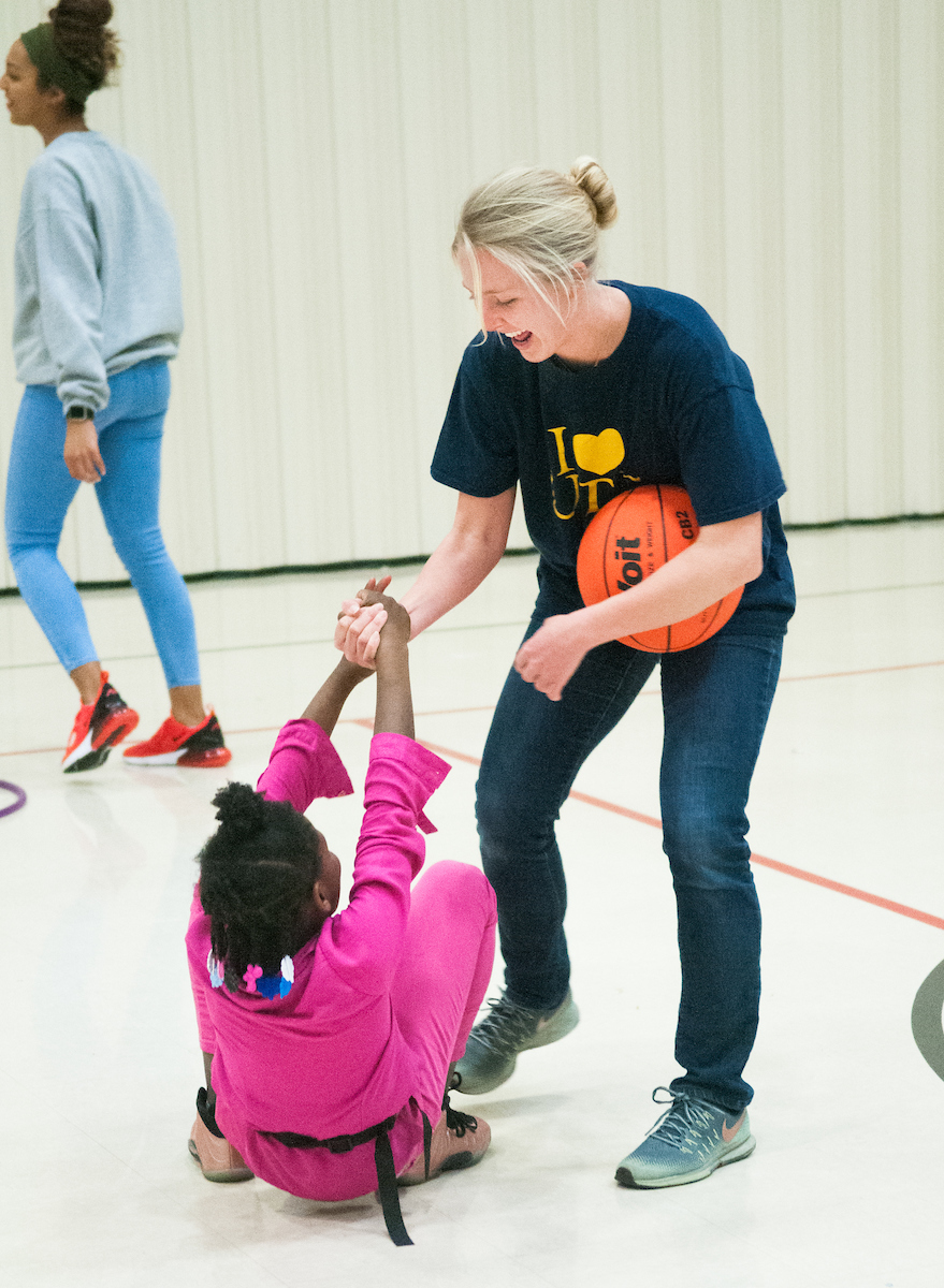 UTC Health and Human Performance student, Lilly McKee lends a helping hand to student at Orchard Knob Elementary School.