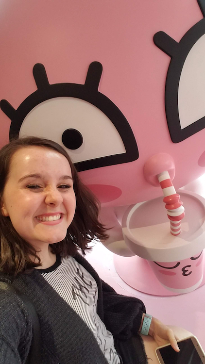 In the Nampo area of Busan, Hannah sits in a cafe next to the super-pink Apeach, a character on the Kakao App, which is sort of like Whatsapp.