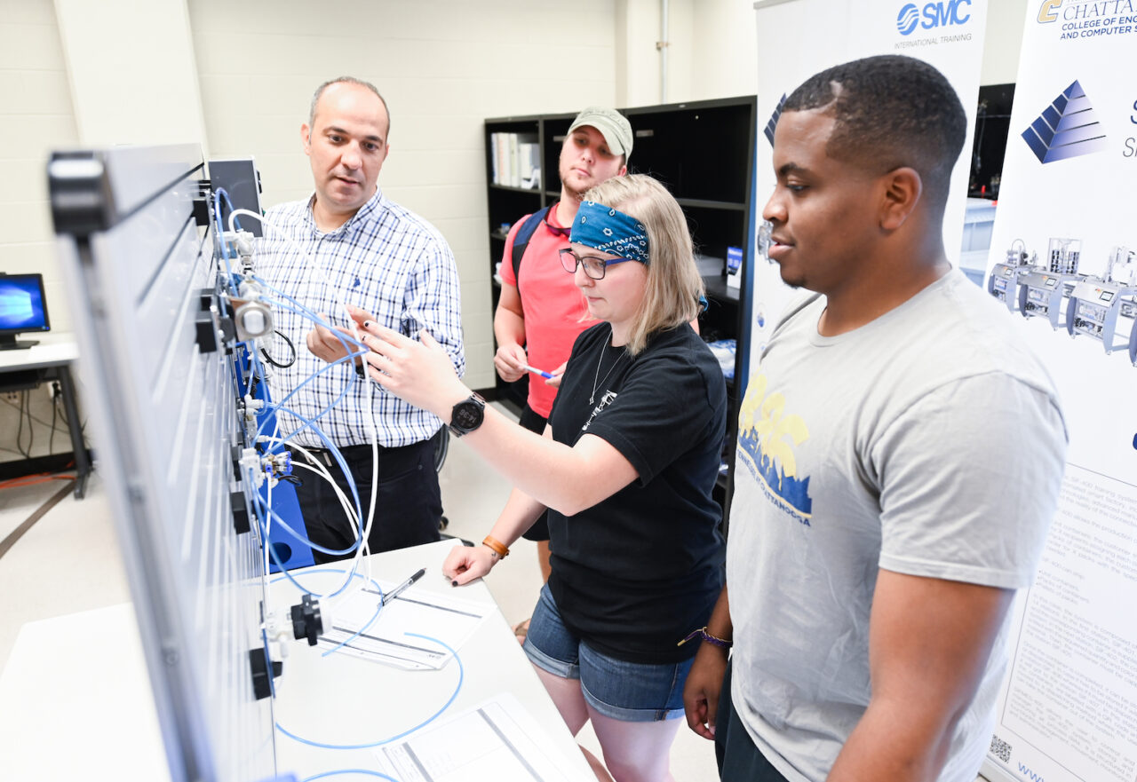 Professor Erkan Kaplanoglu works with students, from left, Erin Watson and Kalen Berry. In the background is student Travis Walker.