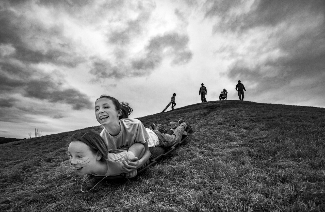 Troy Stolt photo: Brynlee and Emmarie Treece sled down the hill at Renaissance Park in Chattanooga.