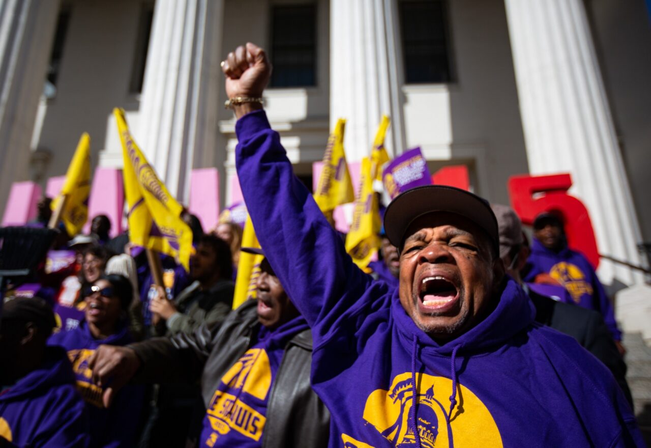 Troy Stolt photo: Lew Moye, president of the Coalition of Black Trade Unionists, raises his fist during a rally and march put on by the group One St. Louis. The rally was to raise awareness of St. Louis janitors' efforts to unionize as well as their demand for their wages to be raised to $15 an hour. Photo courtesy St. Louis Post-Dispatch.