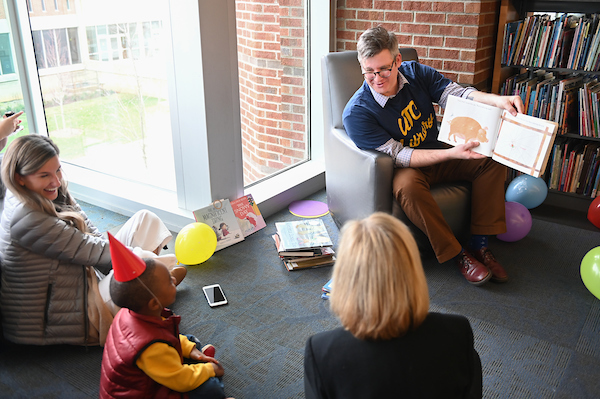 A man reads a children's book.