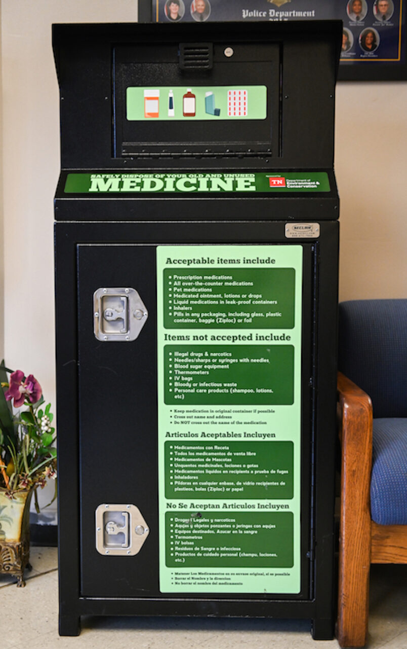 A large secure black box with text about what items are and aren't accepted on the front.