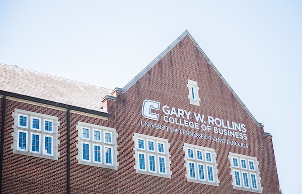 Gary W. Rollins College of Business Building with the title written on the side of the building next to a power C.