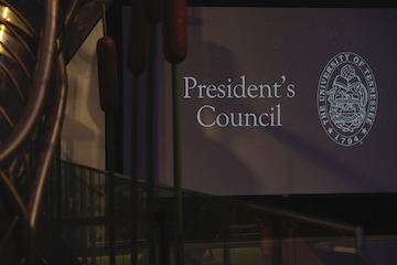 Text on a screen reads "Presidents Council"