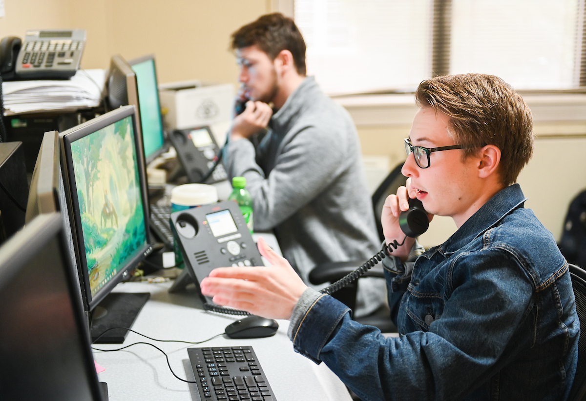 Ryan Martin, front, and Austin Baird work on the IT Help Desk, answering technical questions from students, faculty and staff.