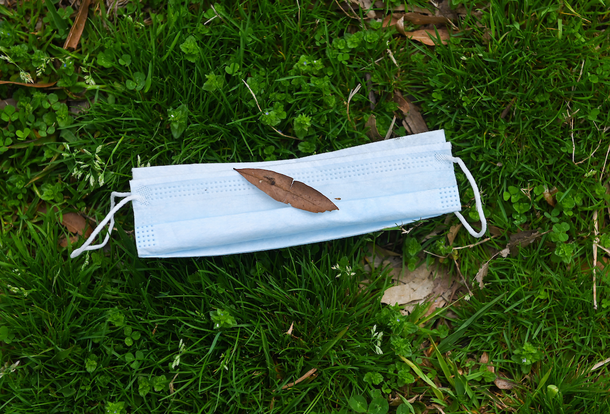 A surgical mask lies on the ground on the UTC campus.