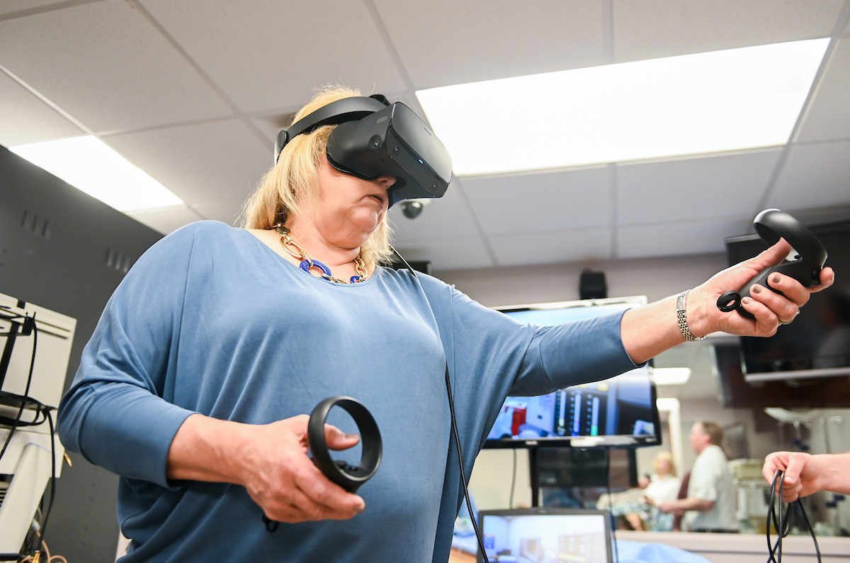 Nursing faculty and staff watch a demonstration of a virtual-reality program that can allow their students to learn remotely.