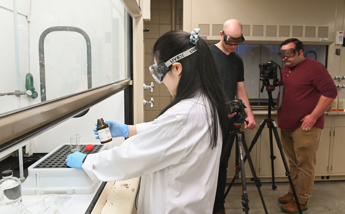 Teaching assistant Allycia Lee conducts an organic chemistry lab lesson as a video is shot of her work. Professors whose classes include labwork must use videotaped online labs through the end of spring semester.