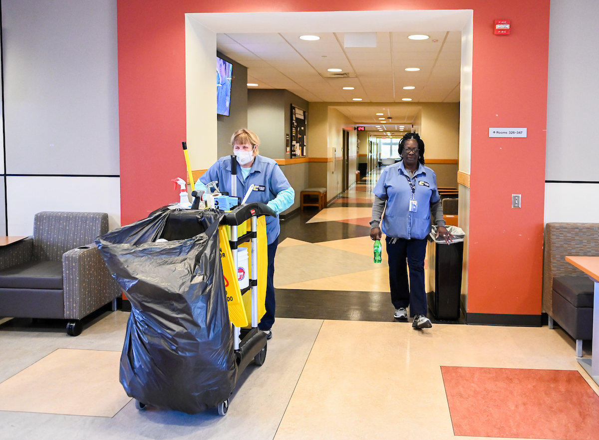 Maintenance employees Cheryl Moore, left, and Donna Bonner work on April 2, 2020.