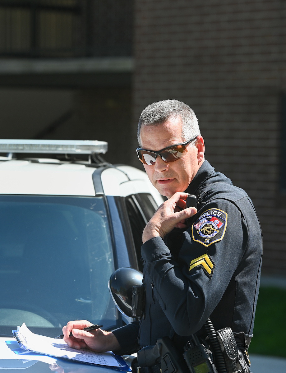 UTC Police Cpl. Ross Brenza carries on a conversation through his shoulder radio on April 2, 2020.