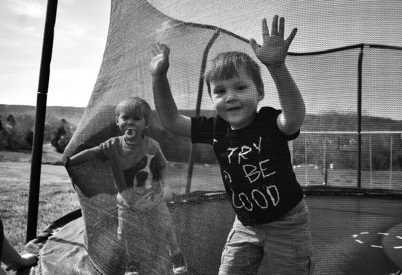 Brothers Tucker Jude and Fielder Lee Richardson play together on the trampoline.