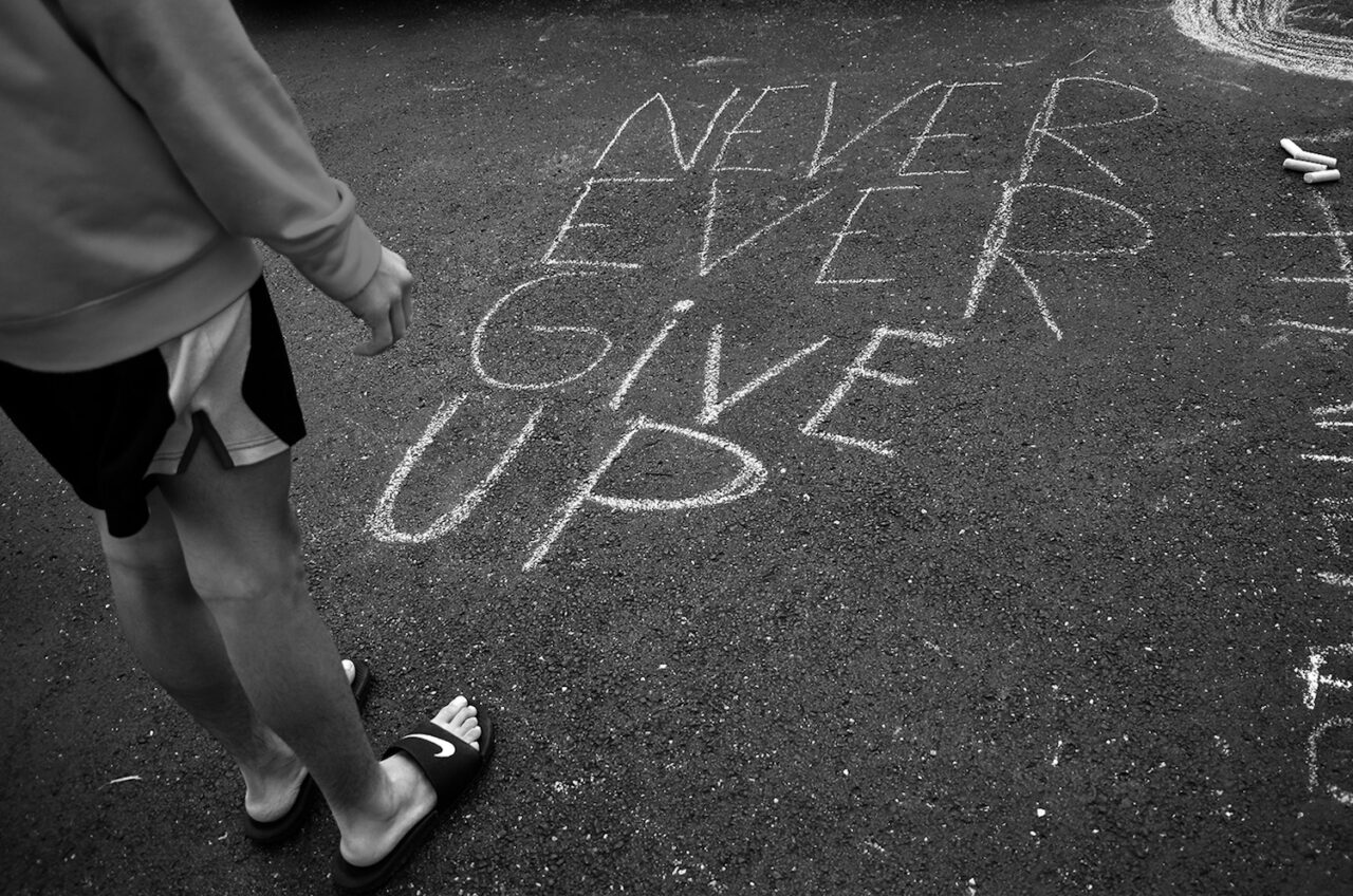 Rian Fann steps back to admire his final chalk message.