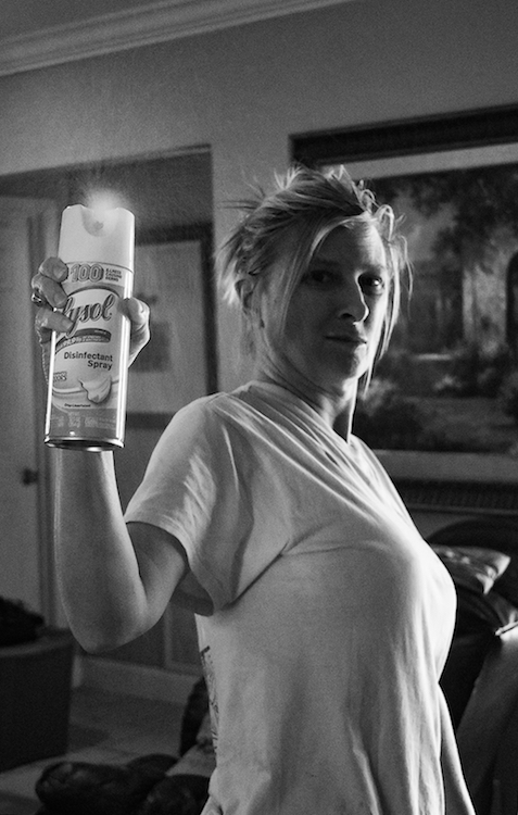 Teresa Fann sprays parts of her house with Lysol for the third time in one day.