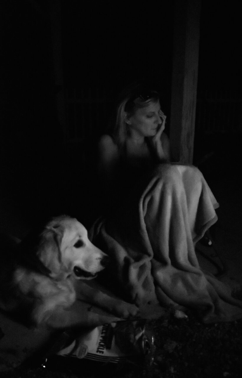 Teresa Fann sits around the fire with her family and dog Blitzen.